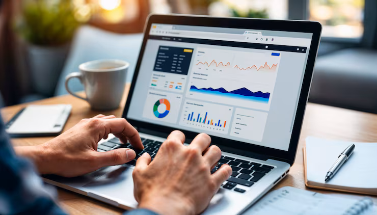 Person using a laptop displaying business analytics and performance dashboards