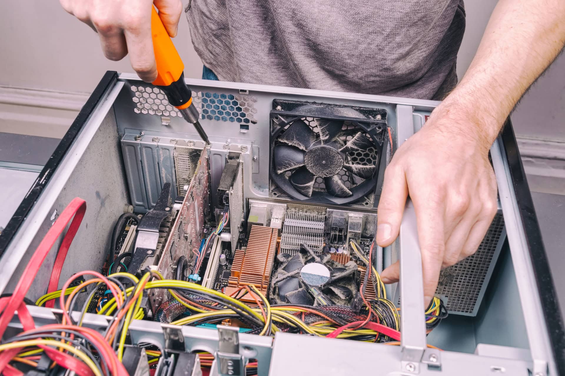 Technician repairing and upgrading desktop computer hardware